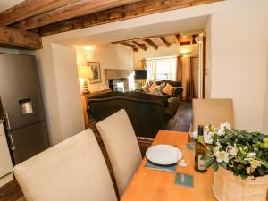 a living room with a wooden table and chairs at Sunny Cottage in Darlington