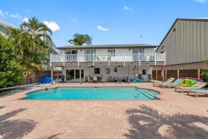 an image of a swimming pool in front of a house at Stunning Waterfront Pool Home Walk to Beach & Restaurants Large Private Pool in Clearwater Beach