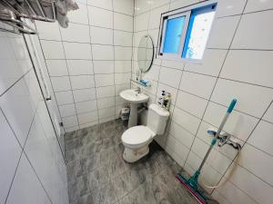 a bathroom with a toilet and a sink at ZhengXing in Tainan