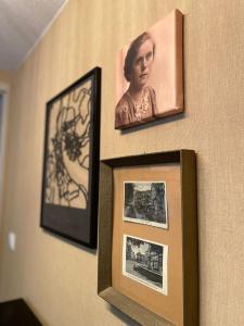 two pictures of a woman are hanging on a wall at Villa Pauline - FeWo "Champagne" in Bad Sooden-Allendorf