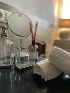 a bathroom counter with a mirror and a towel at Villa Pauline - FeWo "Champagne" in Bad Sooden-Allendorf