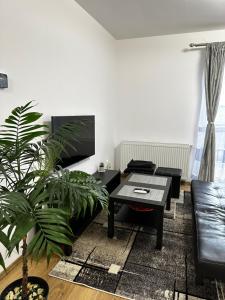 a living room with a table and a couch at Apartament Elena in Sibiu