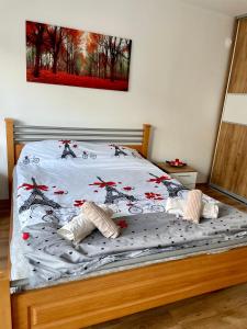 a bed with a comforter on it with at Luxury City Center Apartment in Skopje +19 photos
