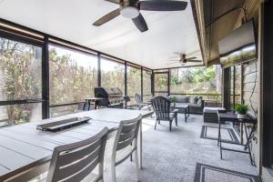 a living room with tables and chairs and windows at Canopy on Cobblestone in Wesley Chapel
