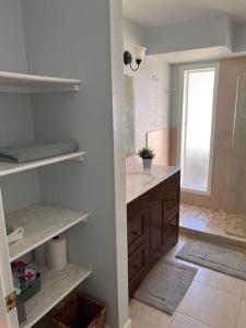 a white bathroom with a sink and a mirror at Super Comfy " Arcade" Home in Cape Coral, Great Location! in Cape Coral