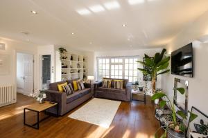 a living room with a couch and a table at Riverwalk Apartment North in Datchet