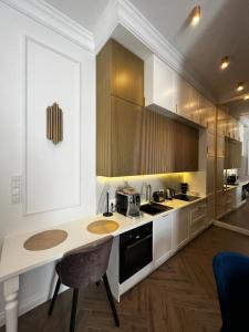 a kitchen with a counter and a table in it at Family & Business Sauna Apartments Sienkiewicza Wesoła No 5 Centrum Downtown - 2 Bedroom with Private Sauna, Bath with Hydromassage, Parking - NEW! in Kielce