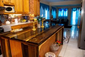 a kitchen with a large wooden island in a kitchen at PRI Guest House in Arnos Vale