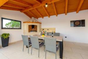 a kitchen and dining room with a table and chairs at Villa AriEm by IstriaLux in Žminj