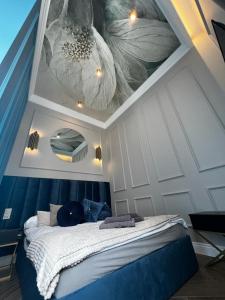 a bedroom with a ceiling with flowers painted on it at Family & Business Sauna Apartments Sienkiewicza Wesoła No 5 Centrum Downtown - 2 Bedroom with Private Sauna, Bath with Hydromassage, Parking - NEW! in Kielce
