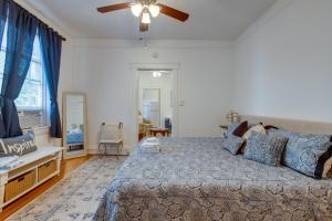 a bedroom with a bed and a ceiling fan at Walkable Savannah Escape in Historic District! in Savannah