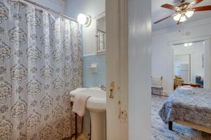 a bathroom with a sink and a shower at Walkable Savannah Escape in Historic District! in Savannah +19 photos