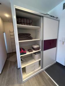a refrigerator with its door open in a room at Apartman Happiness in Sarajevo