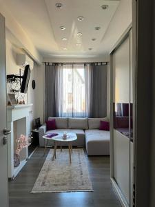 a living room with a couch and a table at Apartman Happiness in Sarajevo