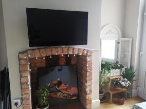a fireplace with a tv on top of it at NEW Derby Pride Park Arena Moorways 4 bedrooms 7 beds -Spacious contractors or group -FREE PARKING in Derby