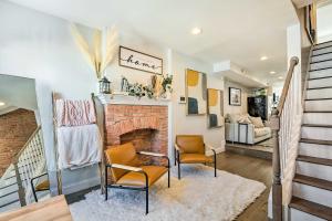 a living room with two chairs and a fireplace at Central and Trendy Baltimore Townhome Pets OK! in Baltimore
