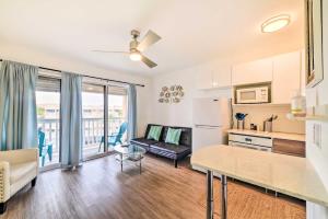 a kitchen and living room with a couch and a refrigerator at Sun-Soaked Texas Condo with North Beach Access! in Corpus Christi