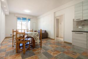 a kitchen and dining room with a table and chairs at Appartamenti PEN in Follonica