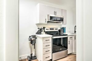 a kitchen with white cabinets and a stove top oven at The Cottages Ski-InandOut Retreat - Hike and Explore! in Beaver