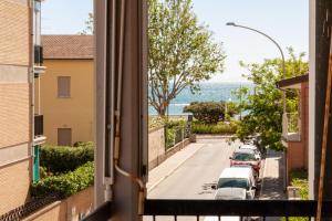 a view from a window of a street with cars at Appartamenti PEN in Follonica