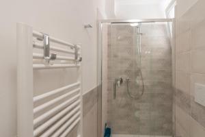 a bathroom with a shower with a glass door at Appartamenti PEN in Follonica +15 photos