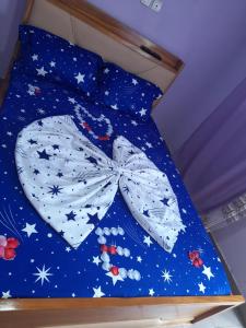 a bed with a blue comforter with stars on it at NPANGOU APPART in Kribi