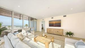 a living room with a couch and a tv at Ten35 Seaside Rentals in Sarasota