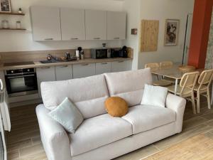 a white couch with a pillow on it in a kitchen at O2MER in Le Portel