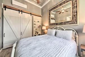 ein Schlafzimmer mit einem weißen Bett und einem Spiegel in der Unterkunft Ladera Wimberley Estate on 13 Acres with Hot Tub in Wimberley