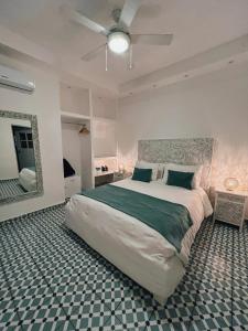 a bedroom with a large bed and a mirror at Mosquito Boutique Hotel Zona Colonial in Santo Domingo