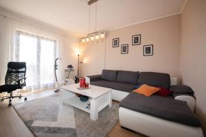 a living room with a couch and a table at Apartman Elvis in Lovran