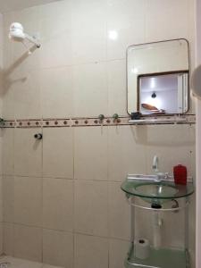 a bathroom with a sink and a mirror at Conforto 100 mts da praia in Barra de São Miguel