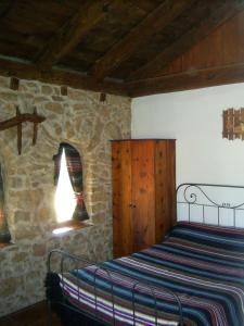 A bed or beds in a room at Masia Del Aragones