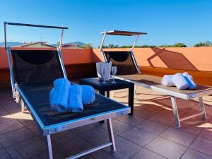 two chairs and a table with blue napkins on it at Villa Marogna in Alghero