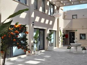 a courtyard with orange trees and a building at Mar Apartments Alicante in Playa de San Juan