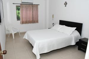 Postel nebo postele na pokoji v ubytování Apartahotel Los Cerezos