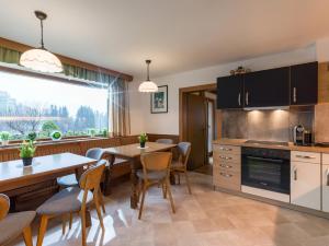 a kitchen and dining room with a table and chairs at Ferienhaus Rauter in Oberndorf in Tirol