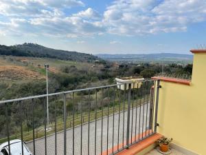 a balcony of a house with a view of a valley at Bilocale moderno 4 posti vicino al mare in Scarlino