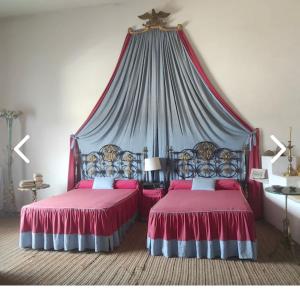 a bedroom with two beds with a canopy at Résidence Cala Montgo in L'Escala +153 photos