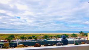 a view of a beach with palm trees and the ocean at Welooveyou Zafiro's in Morro del Jable
