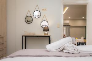 a bedroom with a bed with a mirror and three clocks at P&K LUXURY APARTMENTS 1 in Kalamata