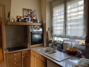 a kitchen with a sink and a microwave at Marie Galante in Sully-sur-Loire +12 photos