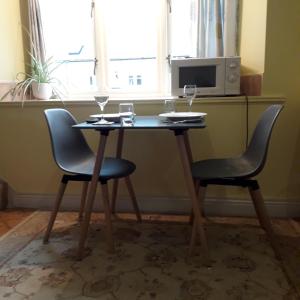 a table and two chairs with wine glasses on it at Castle Court in York