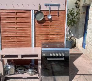 a outdoor kitchen with a stove and a grill at Trullo Cicerone in Martina Franca