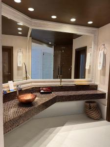 a bathroom with a sink and a large mirror at Las Dunas Grand Luxury in Estepona