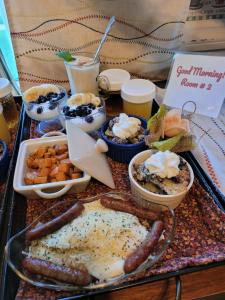 a tray of food with sausage and other foods on a table at The Fresh Coast Inn at Ludington in Ludington