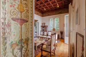 a living room with a table and chairs in a room at Il Parco e gli Affreschi in Varese