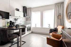 a kitchen with a table and chairs in a room at Beach&Dunes Studio in Zandvoort