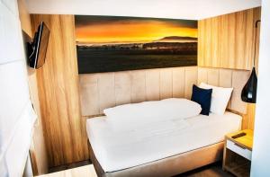 Postel nebo postele na pokoji v ubytování Hotel Wilder Mann