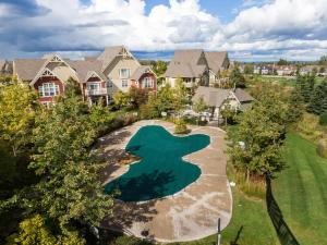 an aerial view of a house with a pool in the yard at Rivergrass Home with Mountain and Golf Course Views in Blue Mountains